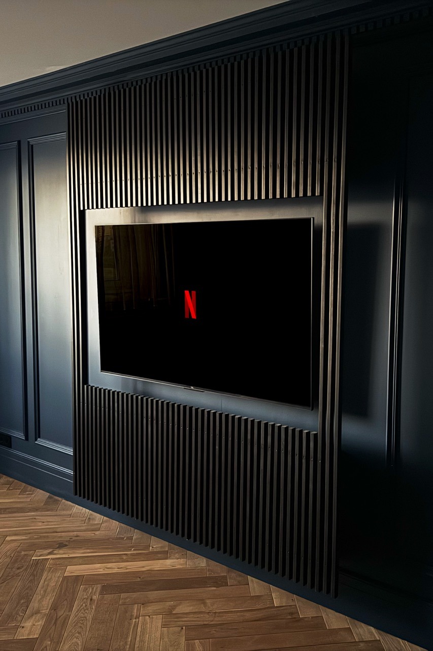 Custom TV wall — slat panel and screen, front view
