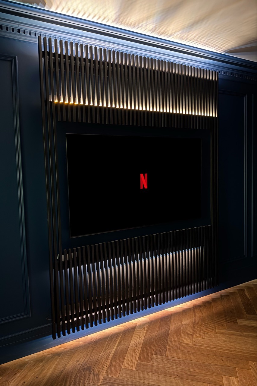 Custom TV wall — full room view with herringbone floor