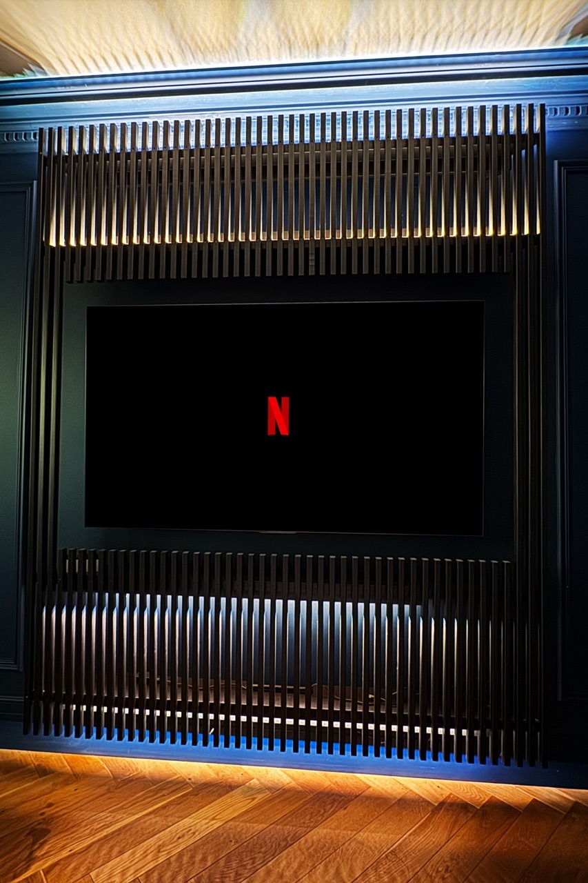 Custom TV wall — detail of the wood slat paneling
