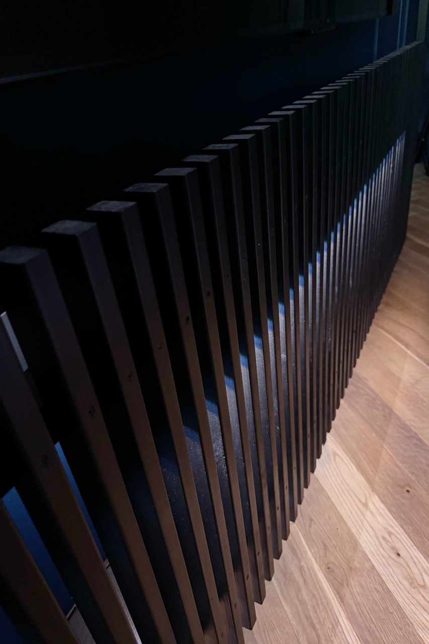 Custom TV wall — close-up of the slat rhythm and floor